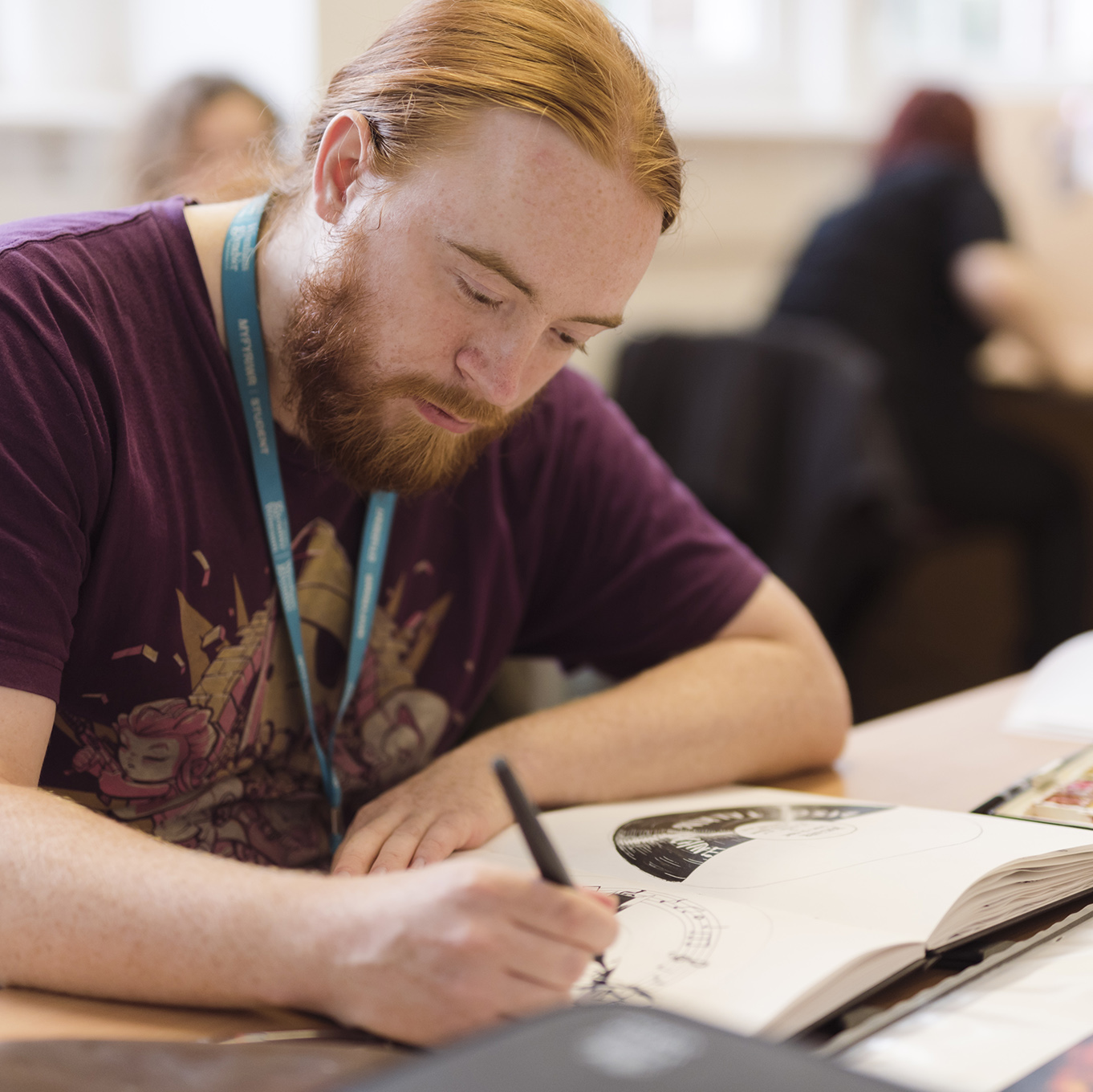 An illustration student works in his sketchbook